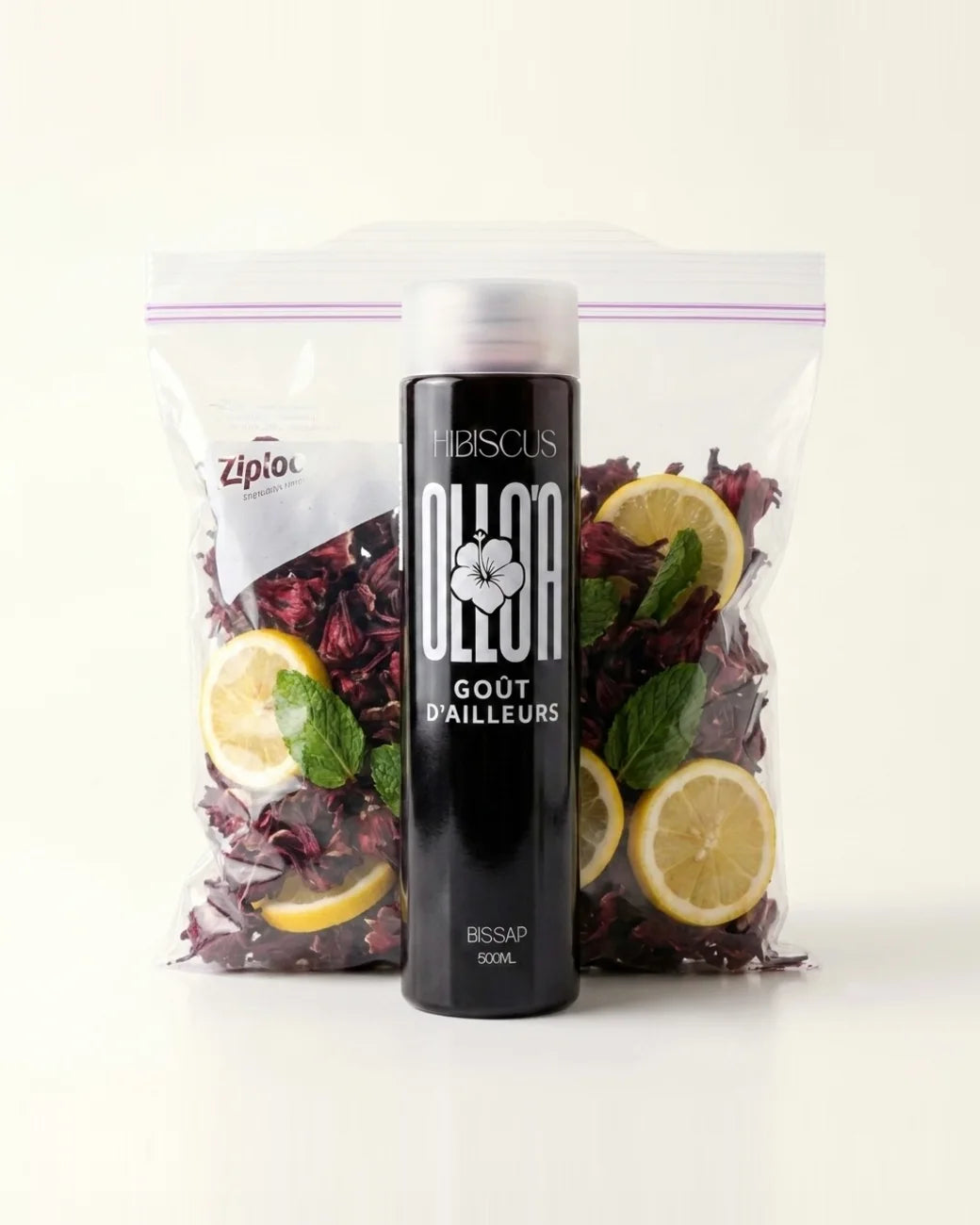 Bouteille de bissap Olloa devant un sac de fleurs d'hibiscus séchées